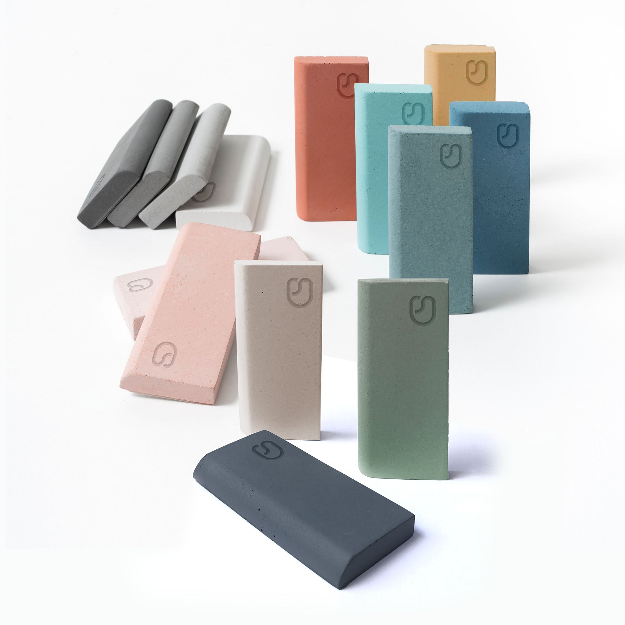 Assorted Concrete Studio concrete colour samples standing upright  and in a stack to show different tones and finishes.