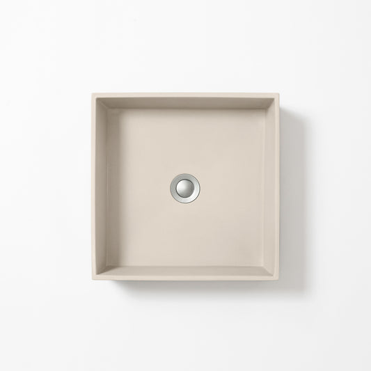 Square concrete basin in Husk, a light beige-grey with soft sand tones, shown from above against a white background.