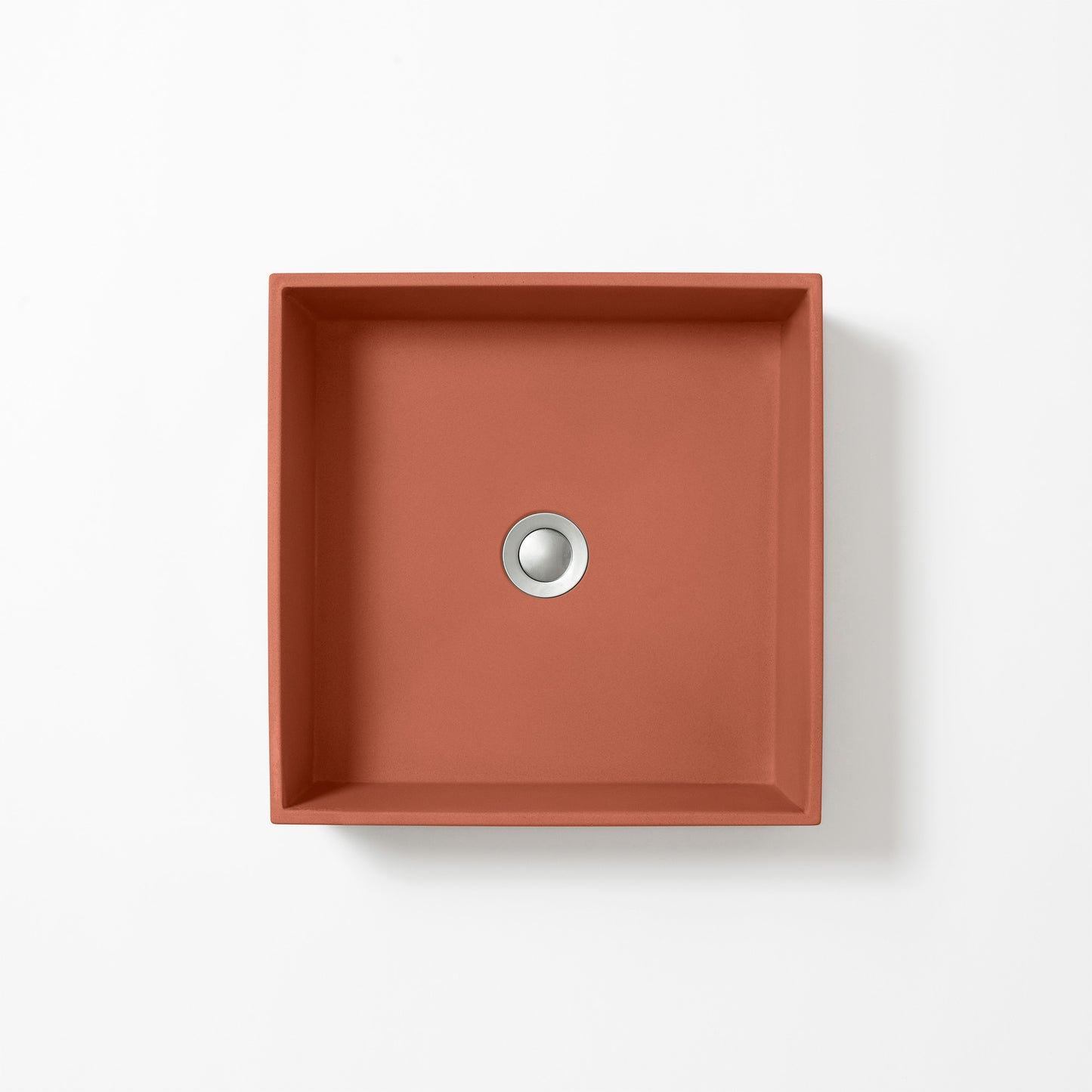 Square concrete basin in Terracotta, a warm orange-red inspired by Mediterranean clay, shown from above against a white background.