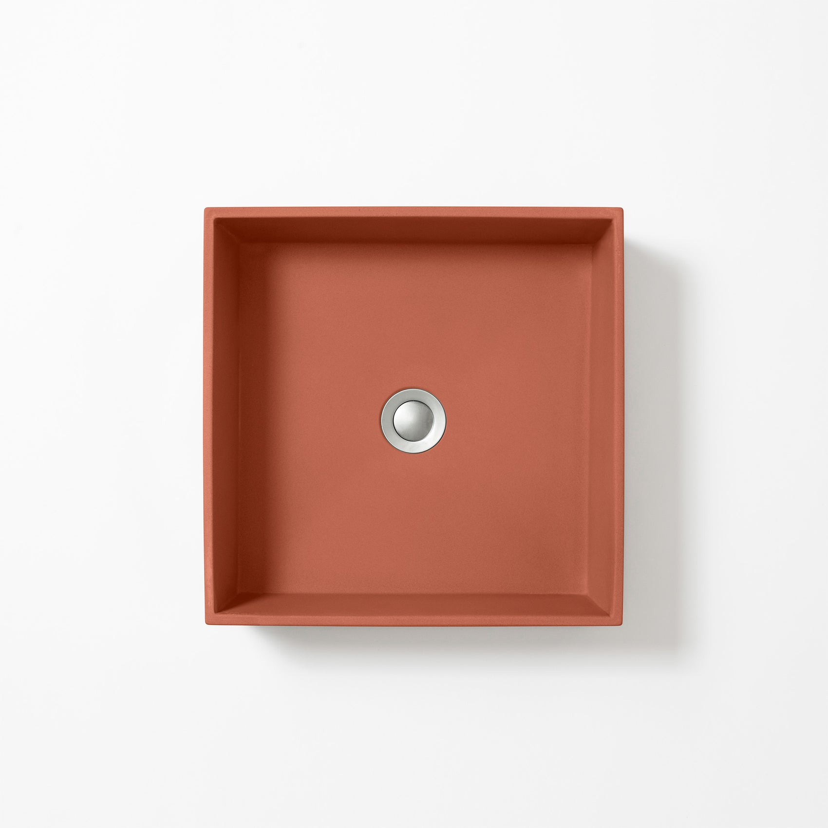 Square concrete basin in Terracotta, a warm orange-red inspired by Mediterranean clay, shown from above against a white background.