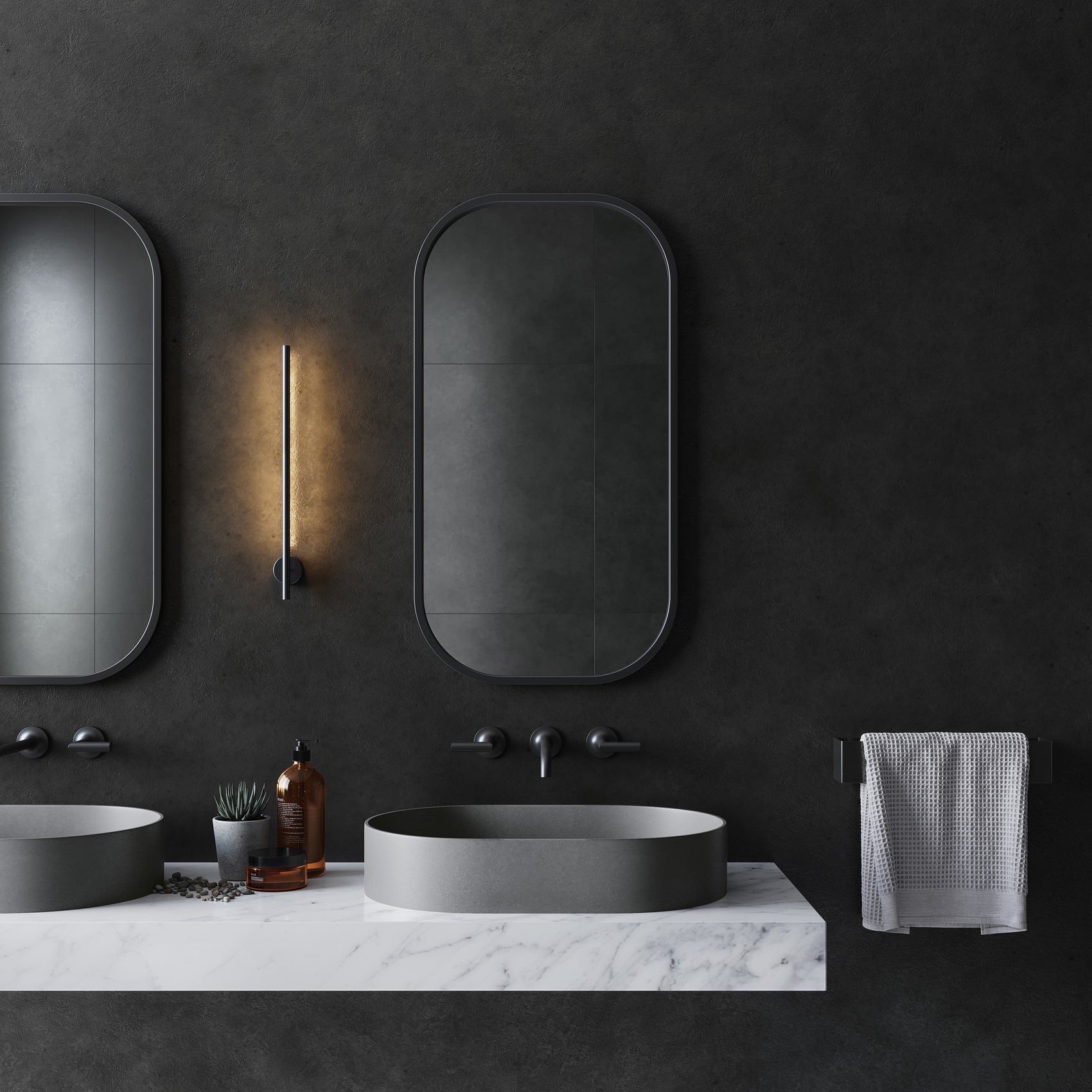 Front view of two Bilya oblong concrete vessel basins installed on a marble countertop in a minimal modern bathroom, with wall-mounted tapware and two backlit mirrors above.